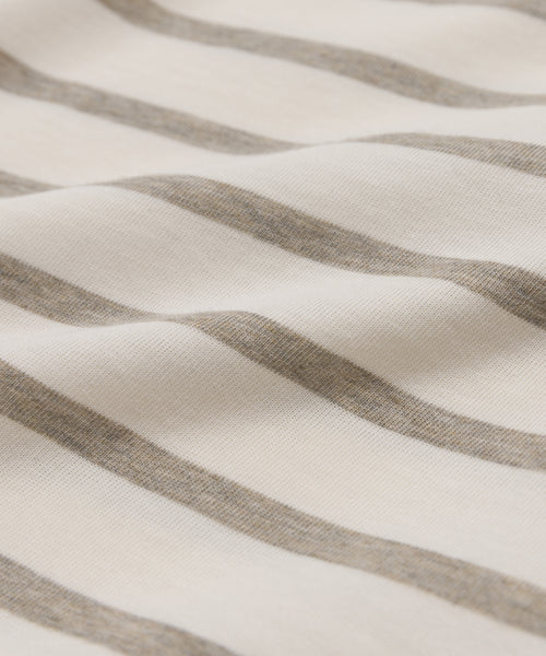 Close-up of the Claude Long-Sleeve Tee made from soft, 100% cotton fabric with horizontal beige and off-white nautical stripes, showcasing gentle folds and a smooth texture.