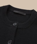 Close-up of the neckline of the Cooper Cardigan, a fitted style with a ribbed collar, two black buttons, and a subtle inner fabric label.