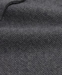 Close-up of the Cooper Cardigan’s dark grey wool fabric, highlighting its soft, textured surface, fine weave pattern, gentle folds, and smooth, slightly fuzzy appearance.