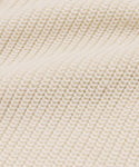 Close-up of cream-colored, ribbed knit with a textured, wavy surface—ideal for the Cotton Hayes Crewneck Cardigan, perfect as a lightweight summer layer or cozy cotton sweater.