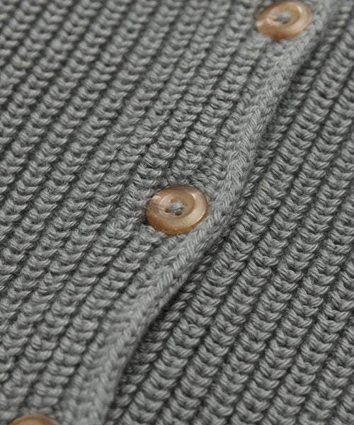 Close-up of the Cotton Hayes Crewneck Cardigan in gray, showcasing its ribbed cotton texture and three brown round buttons along the seam.