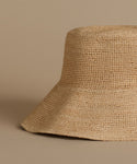 Close-up of a woven straw hat on a beige background