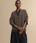 A woman posing for a picture in the Cropped Cashmere Cocoon Cardigan.