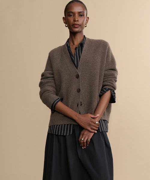 A woman posing for a picture in the Cropped Cashmere Cocoon Cardigan.