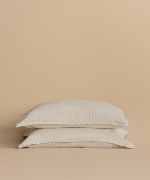 Two Dusk Linen Pillow Shams, set of 2, made in Portugal, are stacked neatly on each other against a plain beige background.