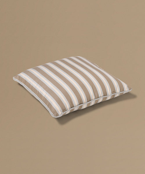 Striped pillow on a beige background