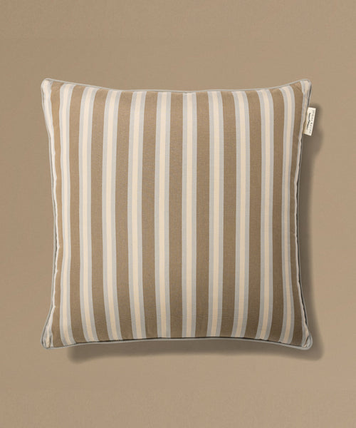 Striped pillow with a label on a beige background