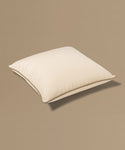 Beige pillow with a tag on a beige background