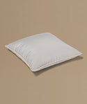 Light gray pillow on a beige background