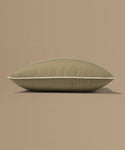Brown pillow with a tag on a beige background