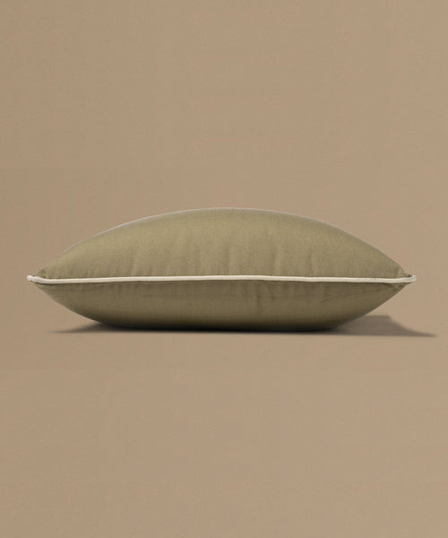 Brown pillow with a tag on a beige background