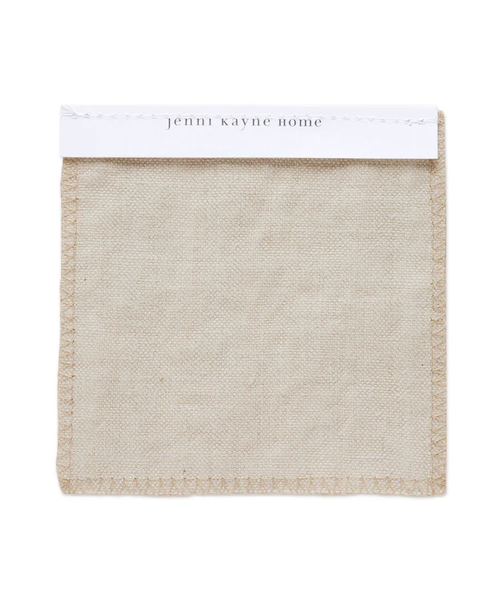A beige Fabric Swatch Drift Linen made from Belgian flax linen, featuring visible edge stitching and attached to a white card labeled jenni kayne home at the top.