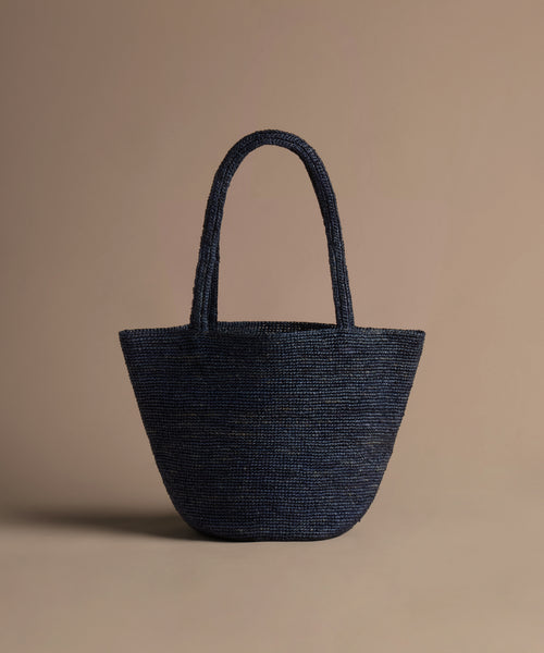 navy hollis bag on a beige background