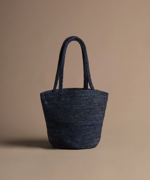 Navy hollis bag on a beige background