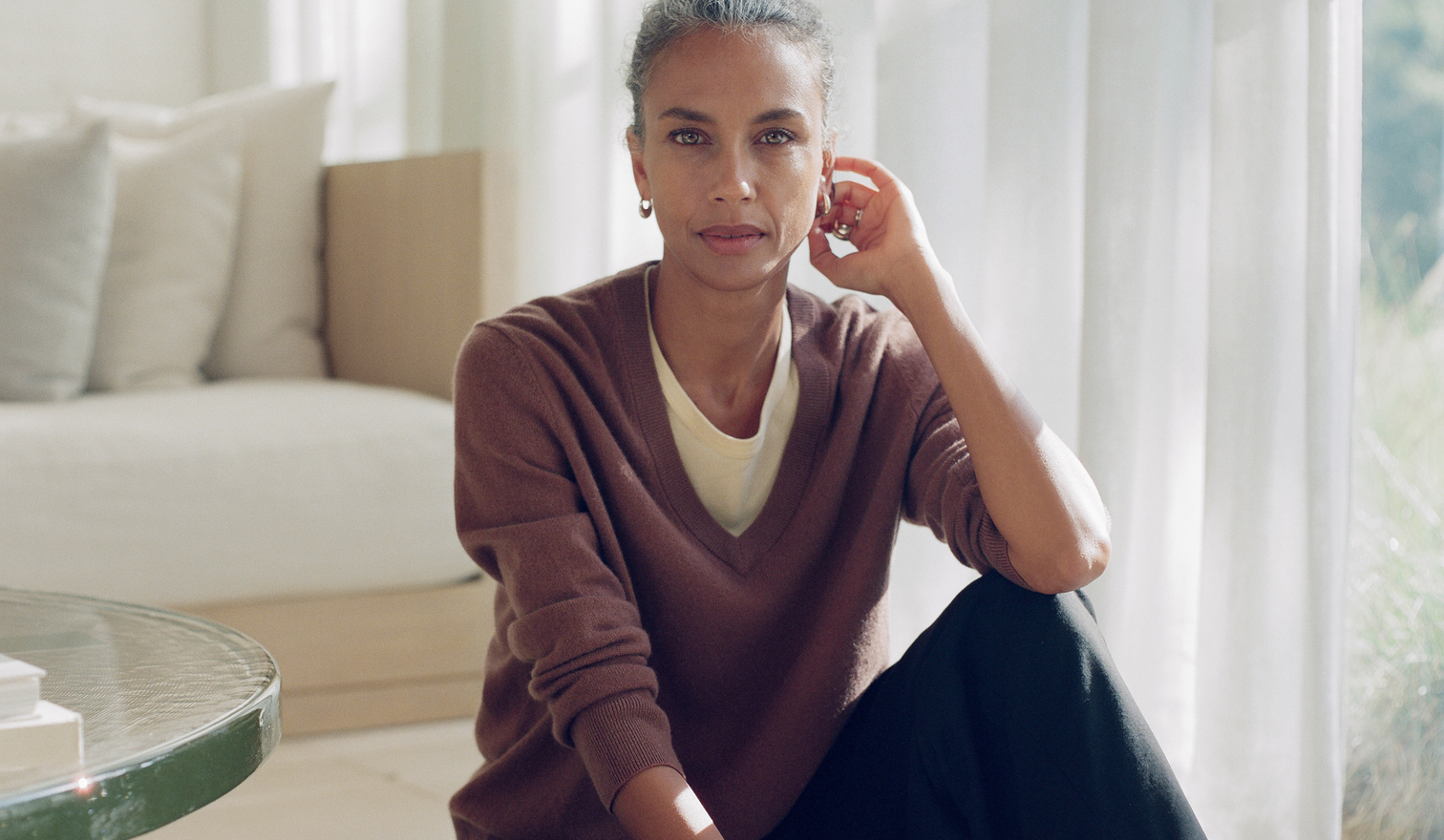 Woman sitting on a couch in a bright living room