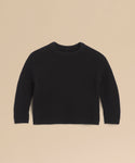 The Kids' Cashmere Fisherman, a black long-sleeve mini sweater with a crew neckline, is displayed flat on a beige background—an ideal cozy kids’ sweater for any occasion.