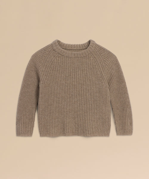 A Kids' Cashmere Fisherman sweater in beige, featuring long sleeves, ribbed knit, and a crew neckline, is laid flat on a light tan background.