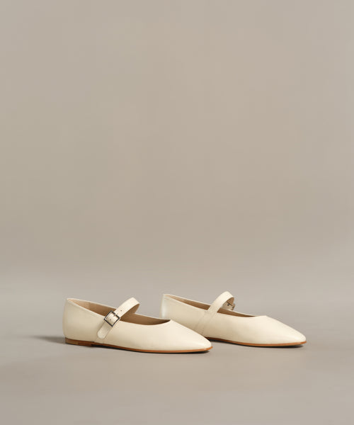 The Lana Flat is a pair of white shoes with a tapered toe, adding a touch of feminine flair.