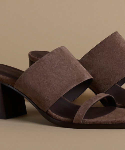 Brown suede sandals on a beige background