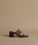 Brown sandal with a heel on a beige background