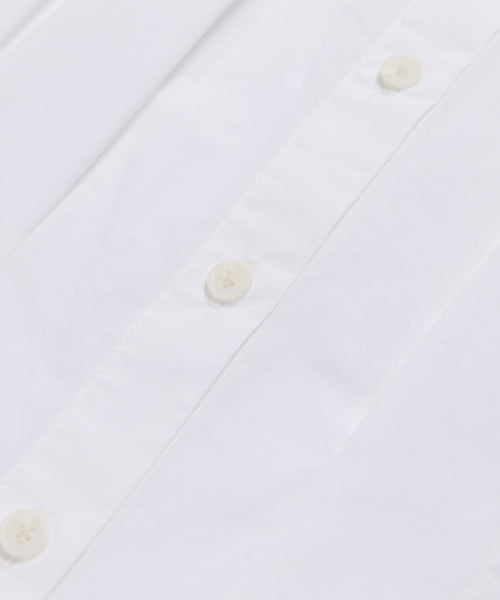 Close-up of the Lara Top, showcasing its Italian washed poplin fabric with white buttons and precisely sewn buttonholes along the front placket.