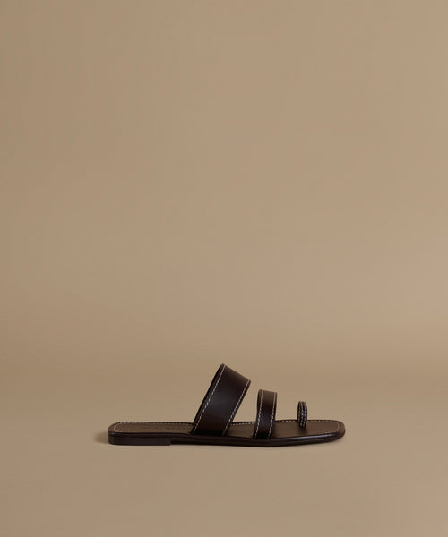 Brown sandal on a beige background