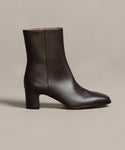 The Leather Bobby Boot, shown in dark brown with a mid-height block heel, side zipper, and smooth finish, is displayed against a neutral background—a stylish and versatile womens boot for any occasion.