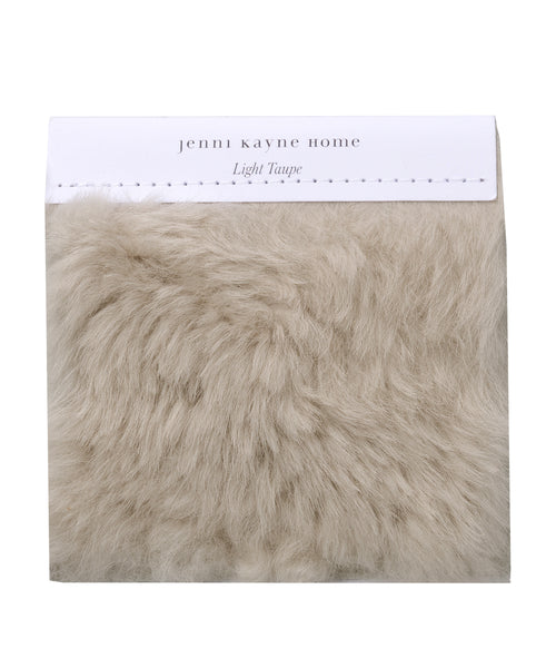 A Fabric Swatch Light Taupe Shearling offers luxurious, faux Icelandic sheep shearling softness in a light taupe hue and complements Jenni Kayne Furniture seamlessly.