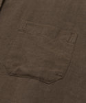 The Linen Logan Shirt, shown in brown, features a single stitched patch pocket on the front for effortless style.