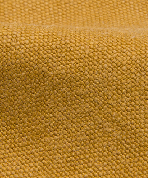 Close-up of Fabric Swatch Mustard Linen, highlighting its coarse woven texture, subtle raised bumps, gentle folds, and varied mustard shading.