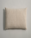 The Luna Pillow, a rectangular beige cotton cushion with a textured fabric cover, is set against a light gray background.