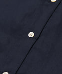 Close-up of the Madeline Shirt in navy blue, featuring white buttons and detailed linen texture with visible stitching.