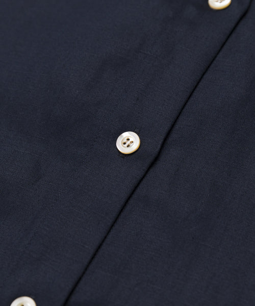 Close-up of the Madeline Shirt in navy blue, featuring white buttons and detailed linen texture with visible stitching.