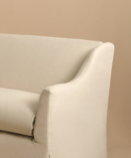 A close-up of the Miramar Sofa, upholstered in light beige Belgian linen with feather down fill, set against a tan background, highlights the armrest, a section of the backrest, and the seat cushion.