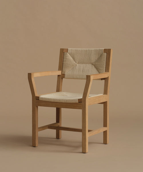A vintage inspired dining chair with wood against a beige background.