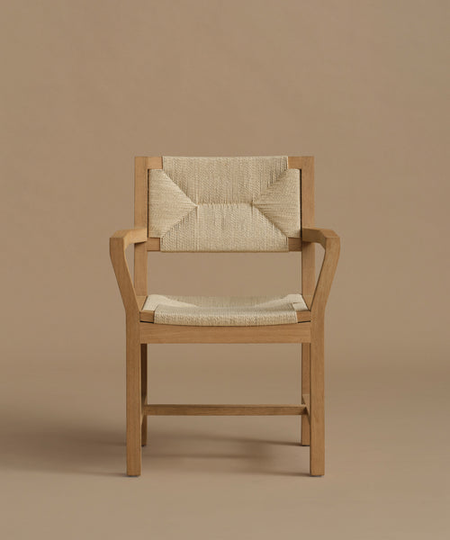 A vintage inspired dining chair with wood against a beige background.