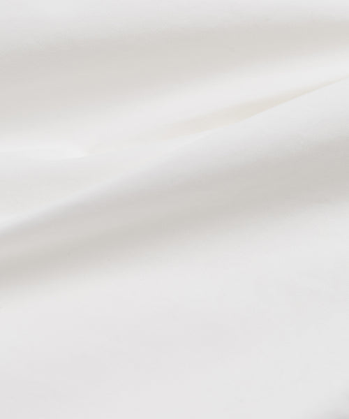 Close-up of smooth white Italian cotton poplin with gentle folds and soft shadows, capturing the minimal and clean aesthetic of the Newport Short—ideal for summer shorts collections.