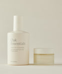 The Double Cleanse Duo by Oak Essentials is shown on a neutral background, featuring minimalist beige and gold packaging for an elegant, refined appearance.