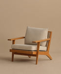 The Outdoor Vista Chair features a modern teak frame, light beige Tempotest fabric cushions, and a woven ECOLENE seat, displayed against a plain beige background.