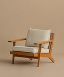 The Outdoor Vista Chair features wide armrests, angled legs, and beige Tempotest fabric cushions on the seat and backrest, shown against a plain beige background.