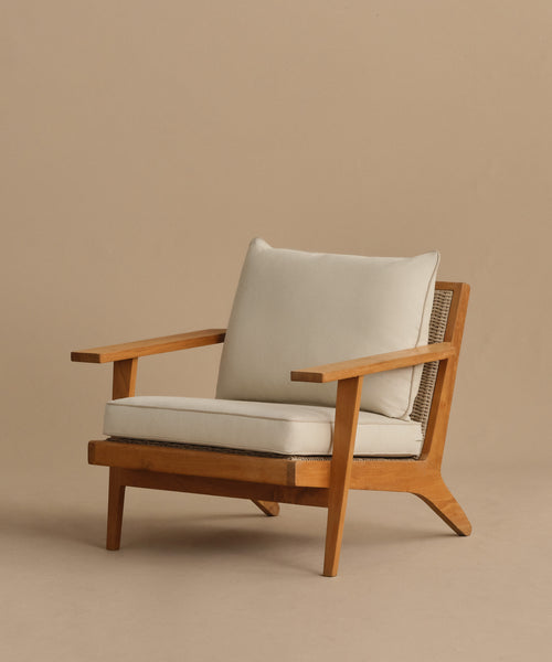 The Outdoor Vista Chair features wide armrests, angled legs, and beige Tempotest fabric cushions on the seat and backrest, shown against a plain beige background.