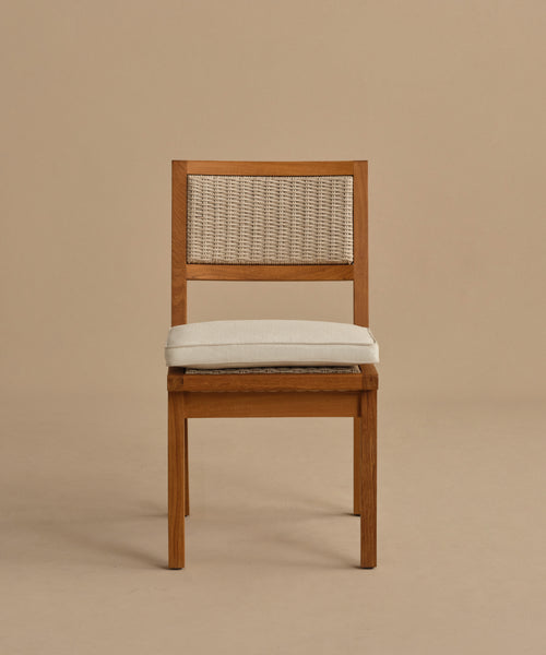 The Outdoor Vista Dining Chair features a wooden frame, woven ECOLENE backrest, and a light-colored cushioned seat, shown against a plain beige background.