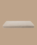 The Outdoor Vista Sofa Cushion is a rectangular beige outdoor cushion with white piping, crafted from premium Italian fabric and displayed against a solid light brown background.