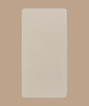 A beige Outdoor Vista Sofa Cushion with rounded corners is displayed on a light brown background.