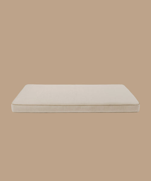 The Outdoor Vista Sofa Cushion, a rectangular beige seat pad from the Vista Collection crafted with smooth Italian fabric, is displayed against a plain tan background.