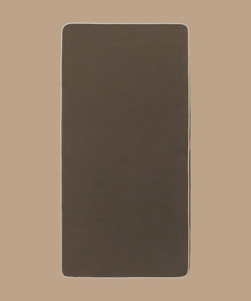 The Outdoor Vista Sofa Cushion features a rectangular shape with rounded corners, dark brown premium Italian fabric, and a thin white border, shown on a light beige background.