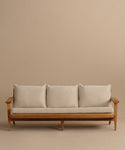 The Outdoor Vista Sofa, featuring a wooden frame with three white Tempotest fabric seat and back cushions, is displayed against a plain beige background.