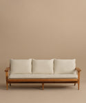 The Outdoor Vista Sofa is a minimalist teak sofa featuring three Tempotest fabric seat cushions and three back cushions, displayed against a plain beige background.