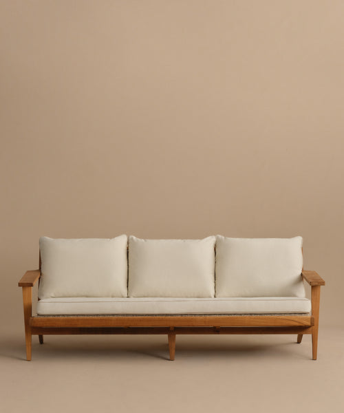 The Outdoor Vista Sofa is a minimalist teak sofa featuring three Tempotest fabric seat cushions and three back cushions, displayed against a plain beige background.