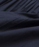 Close-up of dark navy blue Italian washed poplin fabric with visible stitching and gentle folds, offering a soft, smooth texture—ideal for the Peninsula Dress or other breezy sundress styles.